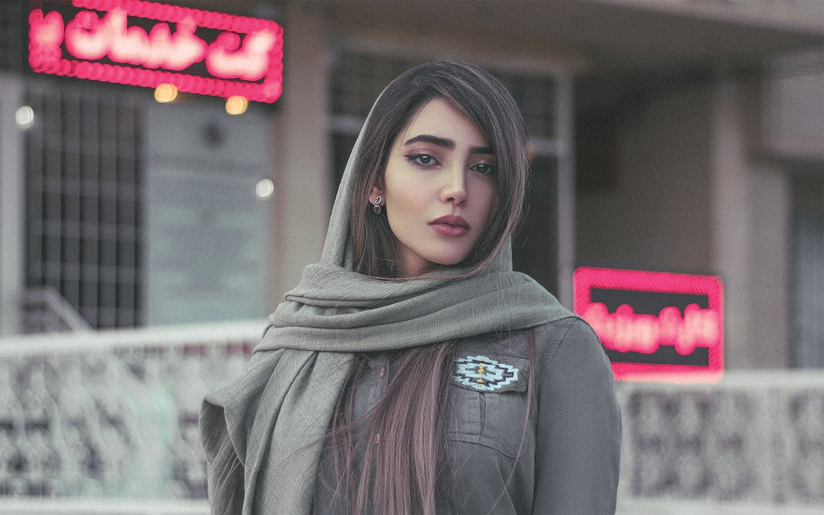 a woman with long hair wearing a scarf