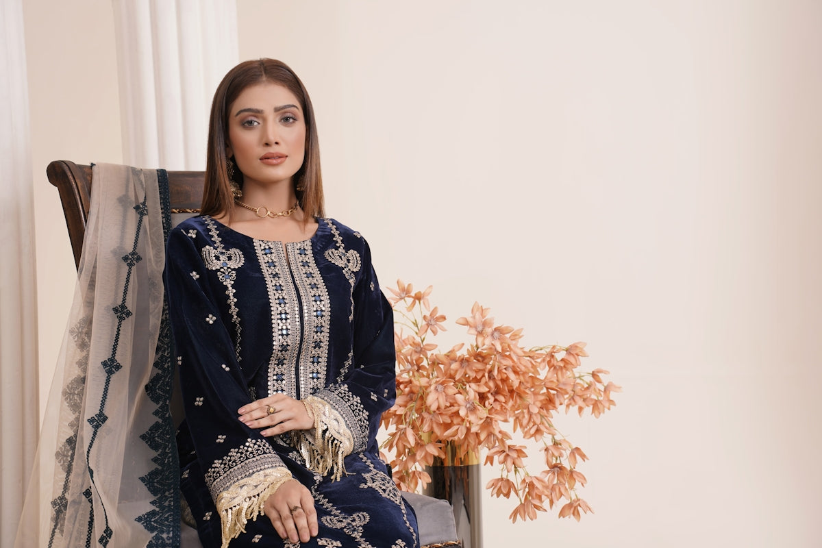 a woman sitting on a chair in a blue dress